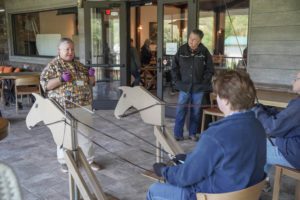 Students learning to drive with wooden horses