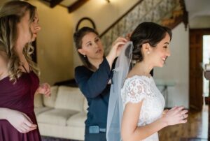 Bride getting ready with help from a wedding planner. Amber Dorn Photography