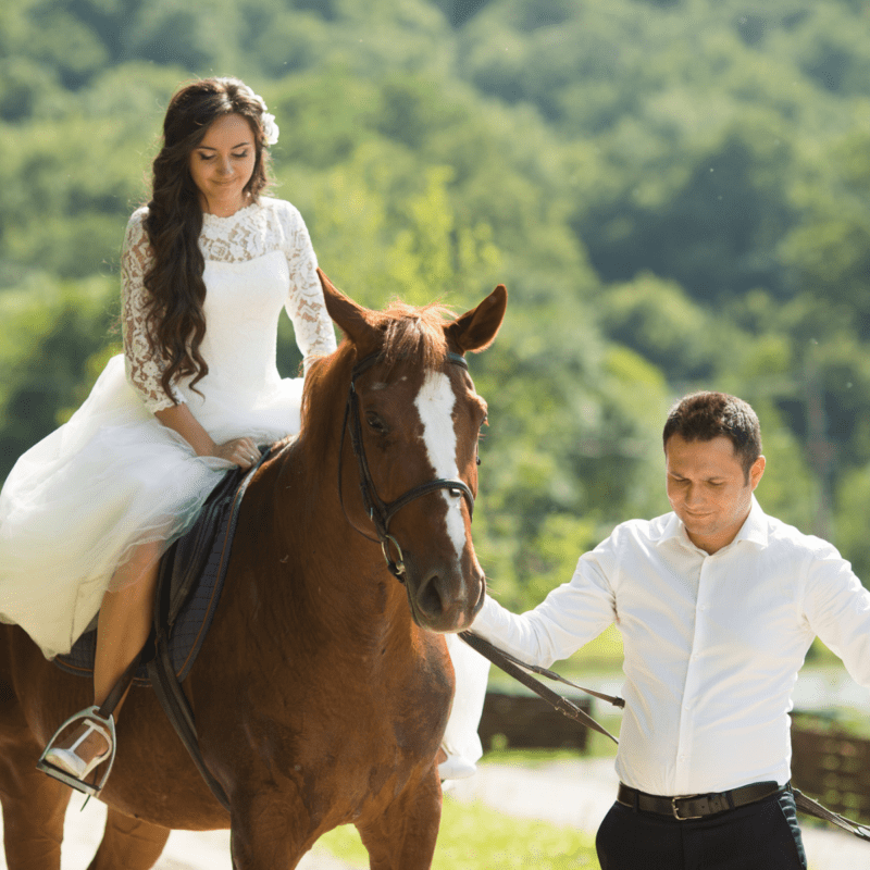 Bride riding a horse to ceremony black prong